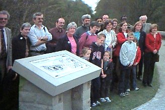 Dr Boucher's family gather round the plaque after its unveiling