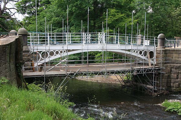 The restored bridge emerges as the scaffold is dismantled