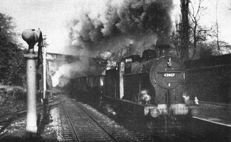 Steam age freight at Marple in 1964. An Up Goods Train of coal empties enters the north end of the station behind a Fowler 4F 0.6.0 43967